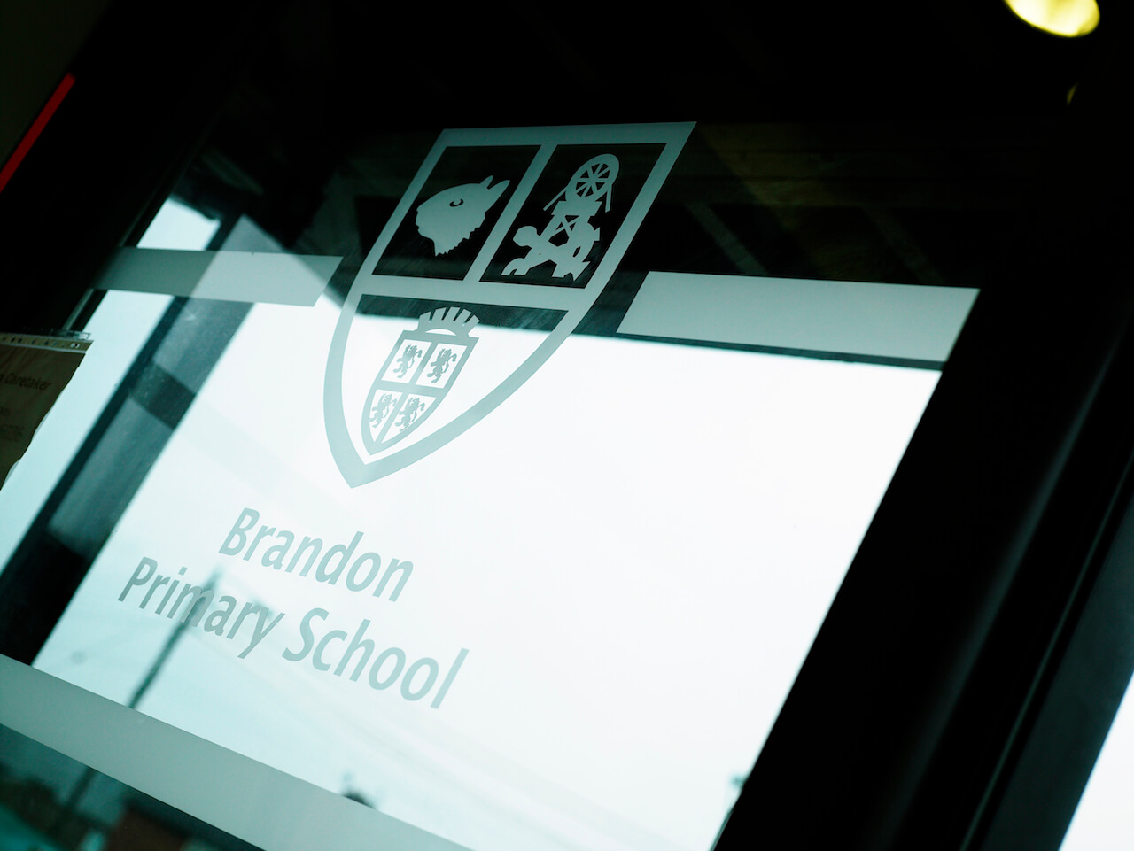 A window manifestation of Brandon Primary School's logo