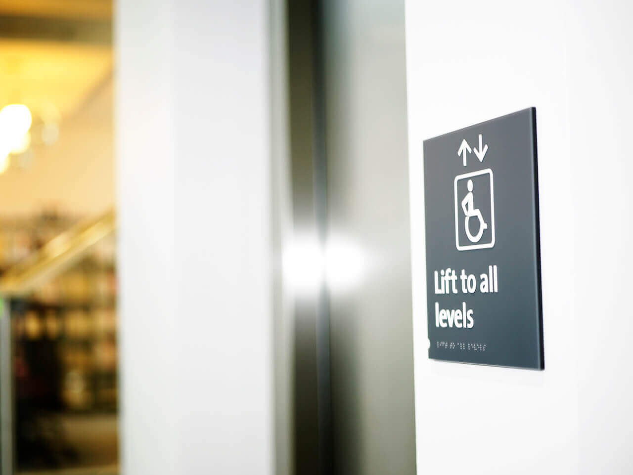 Accessible touch legible signage with Braille and pictograms